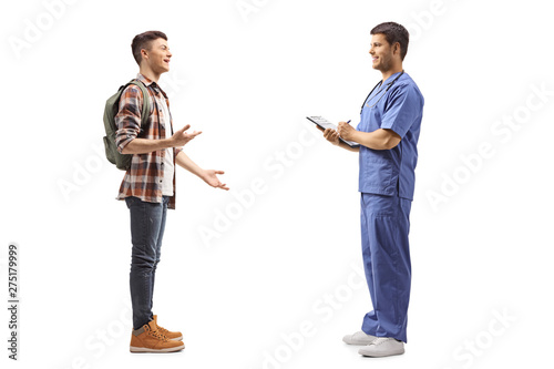 Male student talking to a health pratctitioner in a blue uniform