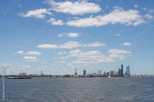 On the horizon are seen the skyscrapers of New York. Skyscrapers of New York in the distance. Bay, blue sky, sunny summer day in New York. © Liudmila