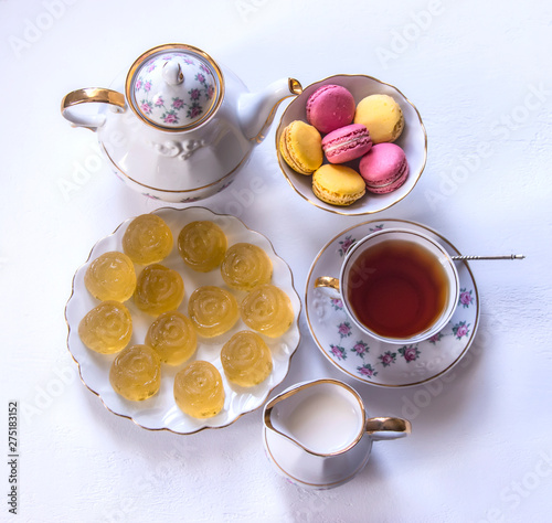Porcelain tea set with milk, macaroni and marmalade.