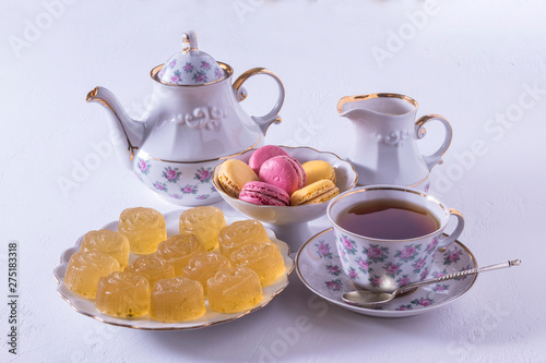 Porcelain tea set with milk, macaroni and marmalade.