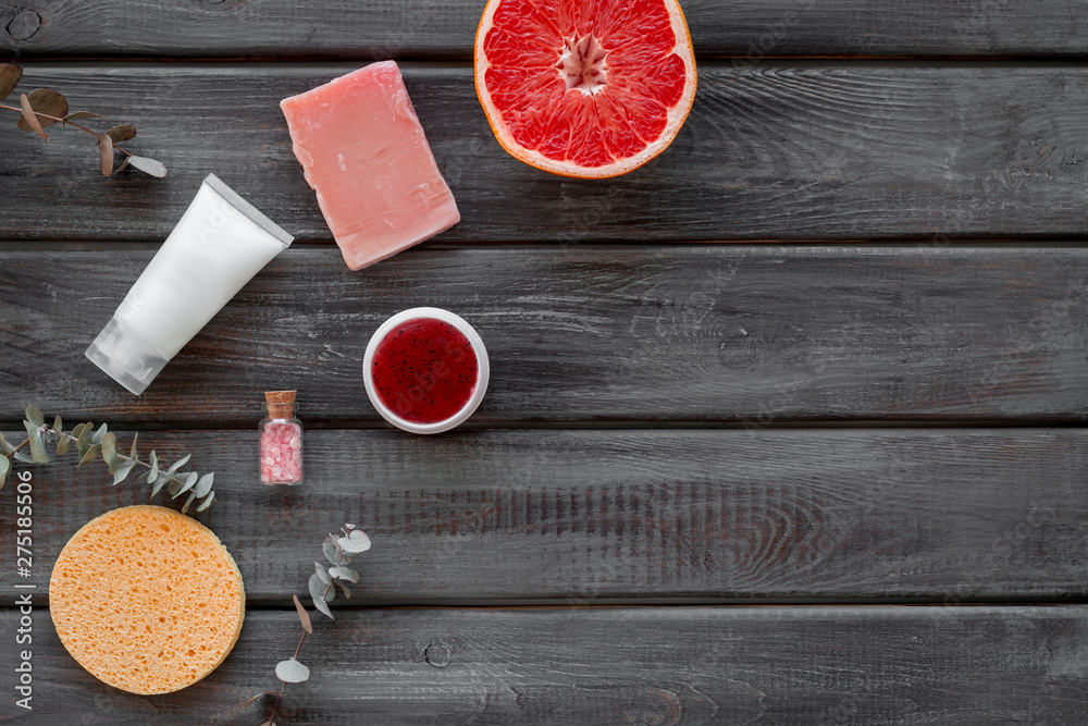 Natural herbal cosmetics with grapefruit on wooden background top view space for text