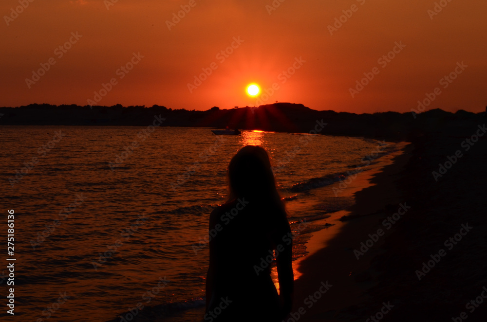 Silhouette mof women  on beach against sky during sunset