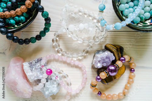 High angle view on crystal perls stones and bracelet on wooden table