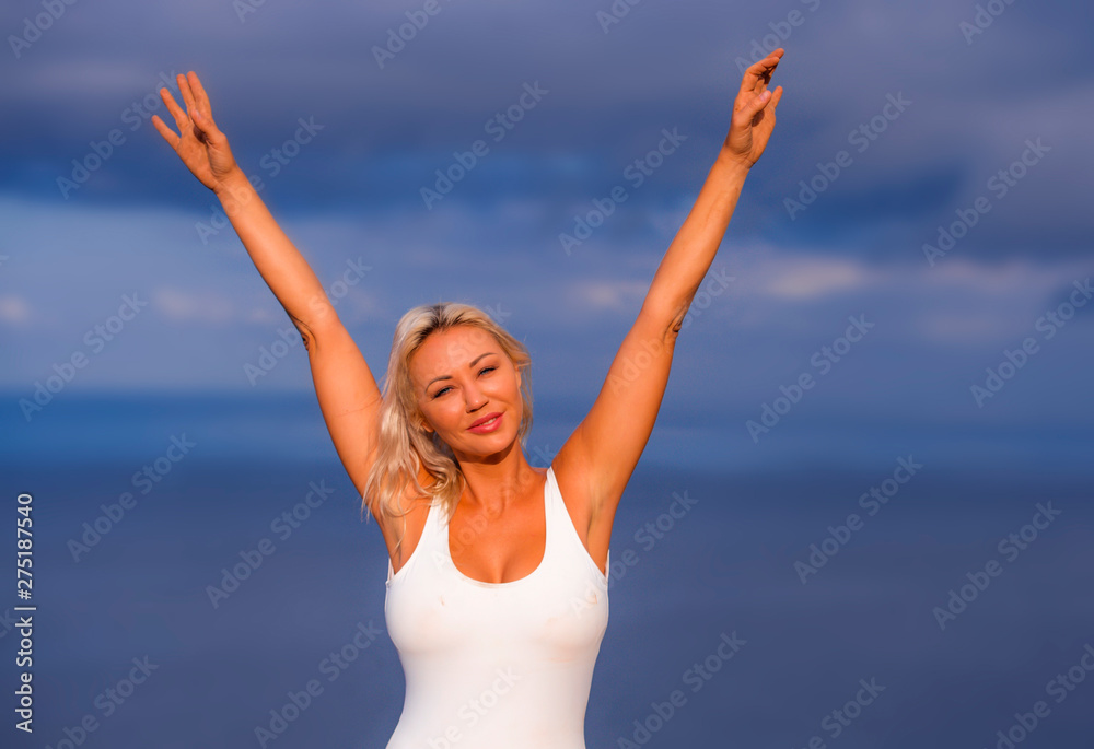 young attractive and beautiful 30s blond hair woman in casual top and denim shorts spreading arms happy and cheerful posing isolated on sea blue and sky young attractive and beautiful 30s blond hair woman in casual top and denim shorts spreading arms happy and cheerful posing isolated on sea blue and sky