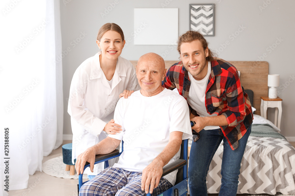 Fototapeta premium Young man visiting his father in nursing home