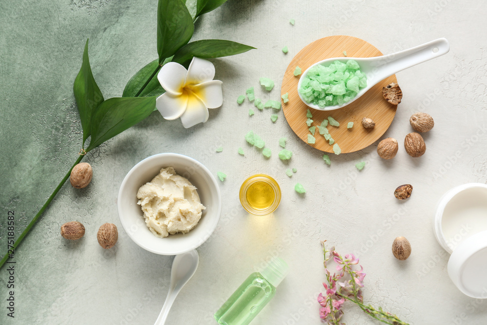 Fototapeta premium Shea butter with cosmetic products on light background