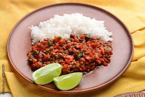 Tasty chili con carne and rice on plate, closeup