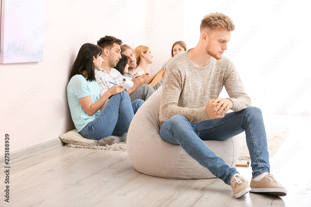 Depressed man at group therapy session Depressed man at group therapy session