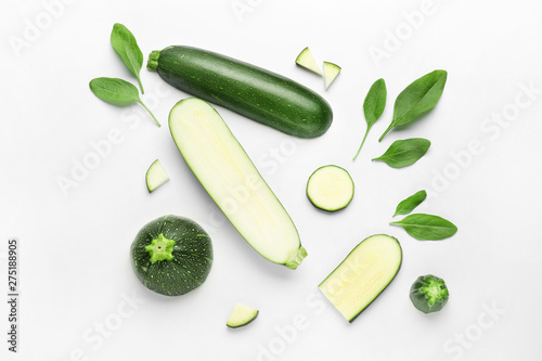 Cut zucchini squashes on white background photo