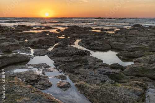 Fototapeta Naklejka Na Ścianę i Meble -  Sunset over the ocean with breaking waves
