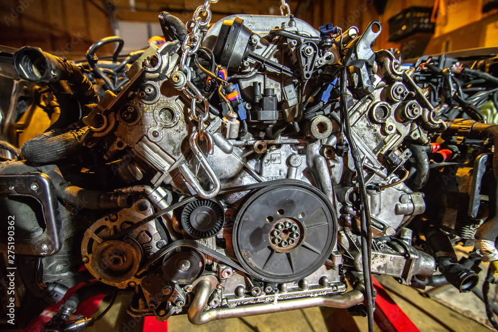 Fototapeta premium v8 engine out on hoist to get rebuilt