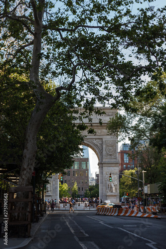 New York, NY / USA - May/27/2019: People walk on a sunny summer day at Washington Square Park.