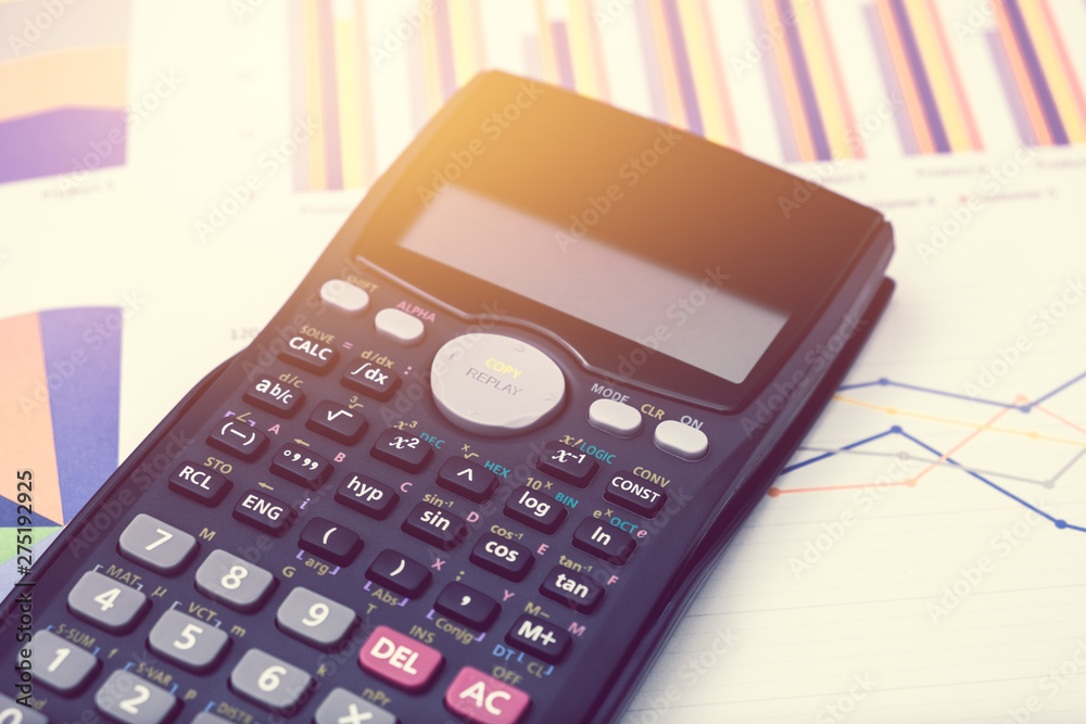 Calculator and pen for data analysis from charts and graph on desk office. business concept Calculator and pen for data analysis from charts and graph on desk office. business concept