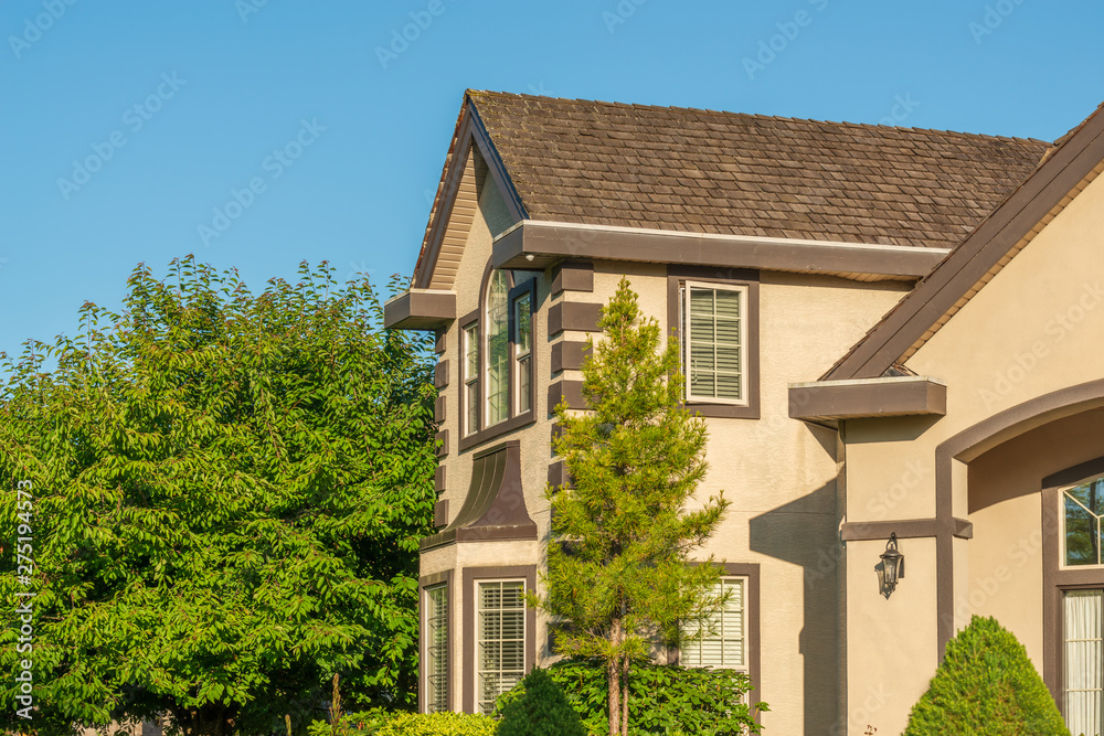 Beautiful exterior of newly built luxury home. Yard with green grass and landscape. Beautiful exterior of newly built luxury home. Yard with green grass and landscape.
