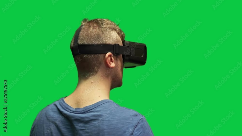 Astonished man with virtual reality headset on green screen Astonished man with virtual reality headset on green screen