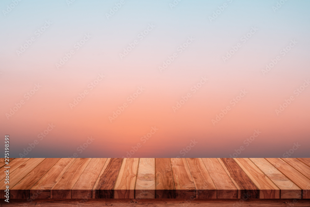Empty wooden table with abstract gradient sunrise in the sky natural background.
