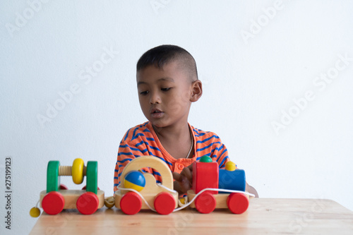 Cute asian boy play toy in room