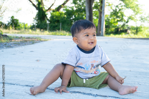 Little baby boy play stick wood on the park