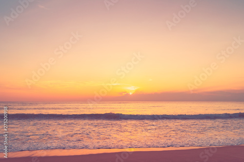 Tropical beach with smooth wave and sunset sky abstract background.