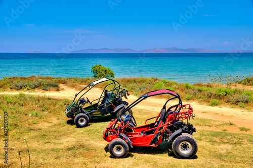 Two buggies standing on the beach photo