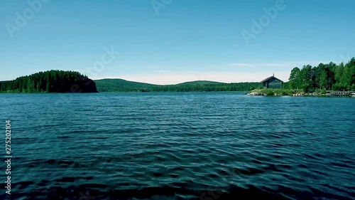 A calm clear sunny summer day in Dalarna, Sweden. Swedens sixth largest lake Siljan sits still and tranquil in these conditions. photo