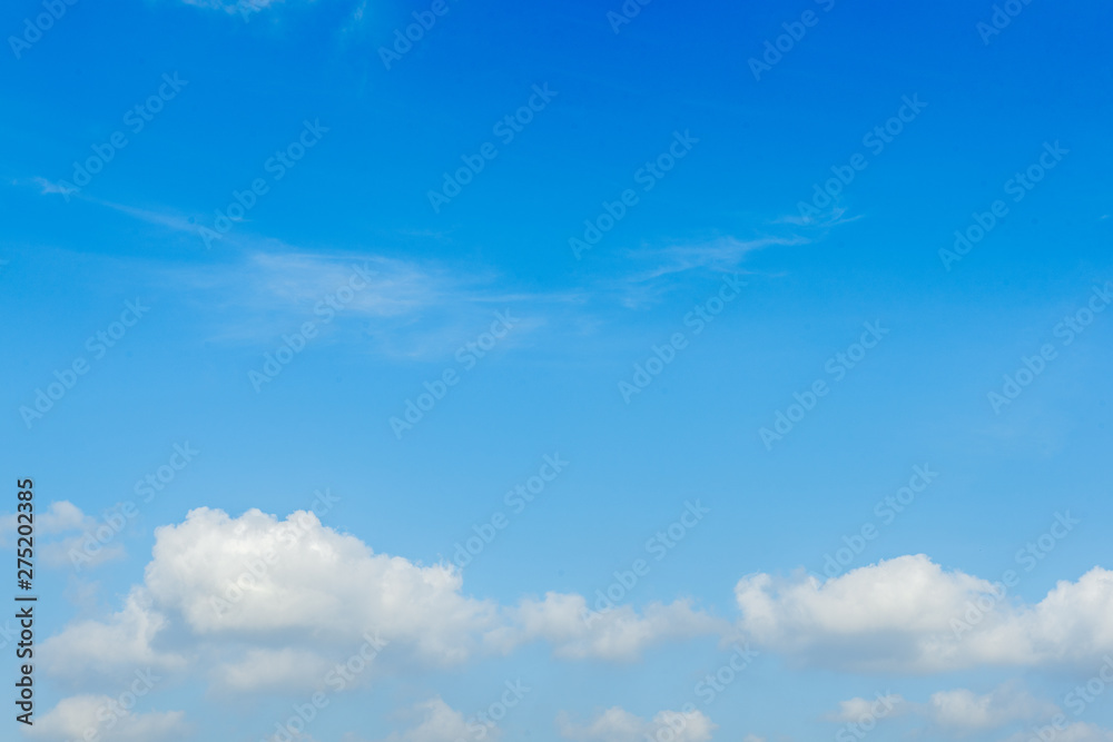 White clouds on a bright day with a blue sky in the background White clouds on a bright day with a blue sky in the background