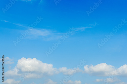 White clouds on a bright day with a blue sky in the background © Chananon