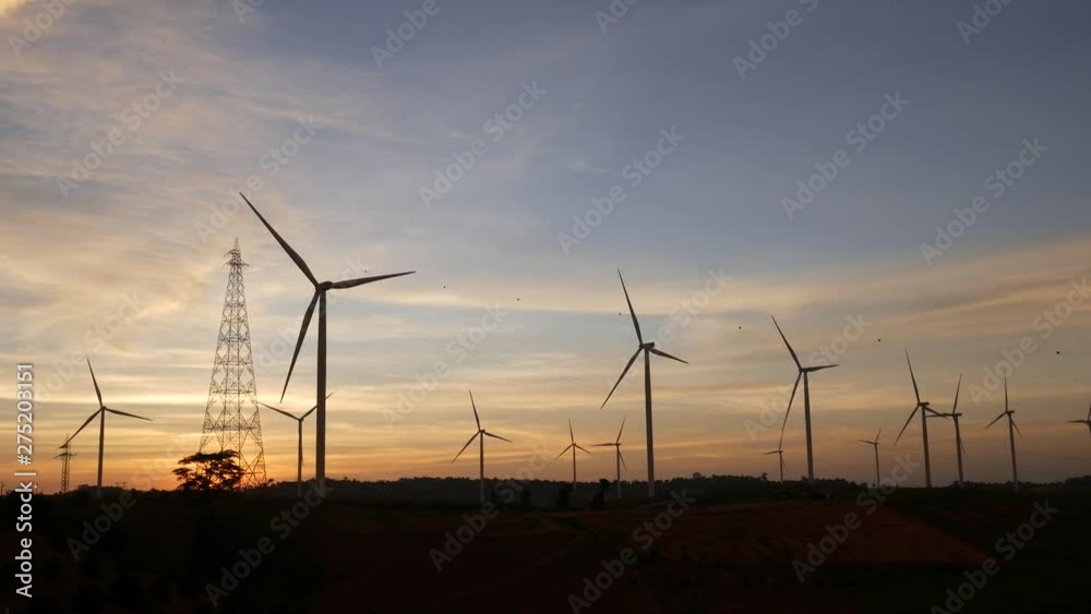 Horizontal Axis Wind Turbine, Wind turbines and power lines against sunset. The clean energy system in Khao Kho District, Phetchabun province, Thailand. Horizontal Axis Wind Turbine, Wind turbines and power lines against sunset. The clean energy system in Khao Kho District, Phetchabun province, Thailand.