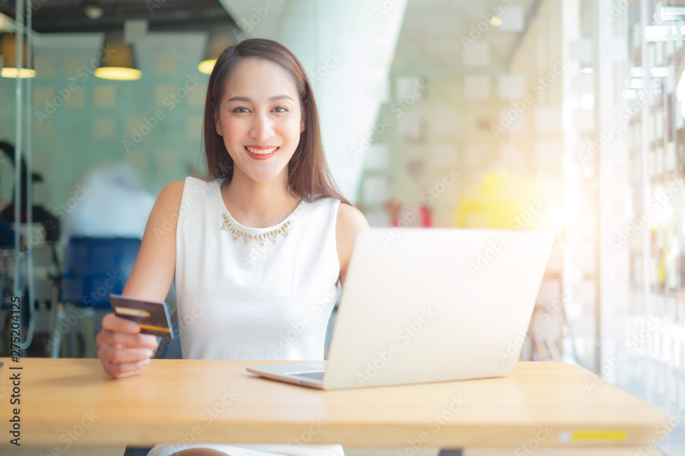 beautiful woman holding credit card using laptop enjoy shopping website online, shopping concept. beautiful woman holding credit card using laptop enjoy shopping website online, shopping concept.