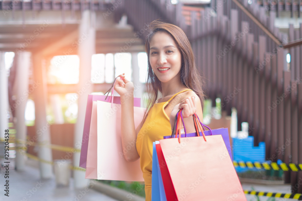 Beautiful women with shopping bags enjoying in shopping standing outdoors of shopping mall, shopping concept Beautiful women with shopping bags enjoying in shopping standing outdoors of shopping mall, shopping concept