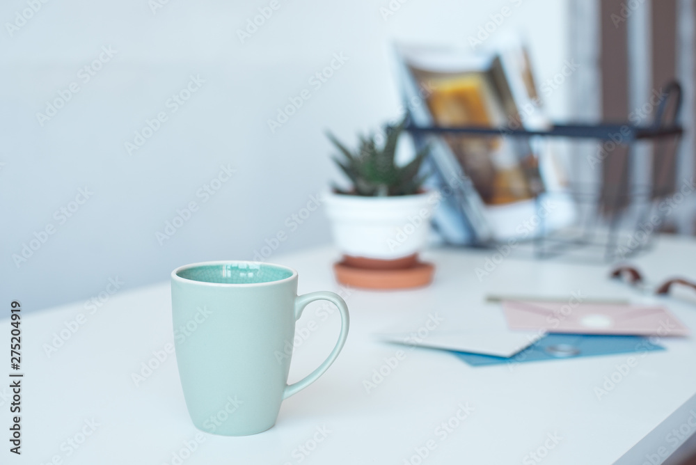 White desk table with copy space, supplies and coffee mug. Front view workspace and copy space White desk table with copy space, supplies and coffee mug. Front view workspace and copy space