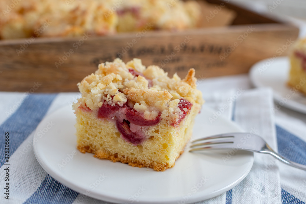 crumble cake in a baking form and pieces of the cake on a table crumble cake in a baking form and pieces of the cake on a table
