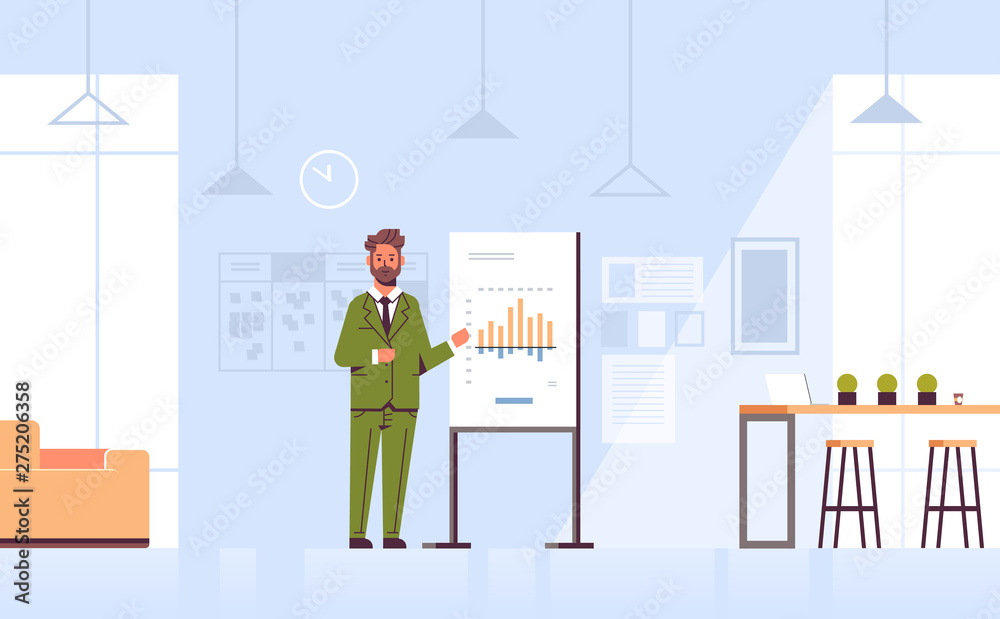 businessman presenting financial graph on flip chart business man making presentation concept speaker at conference meting modern co-working center office interior horizontal full length businessman presenting financial graph on flip chart business man making presentation concept speaker at conference meting modern co-working center office interior horizontal full length