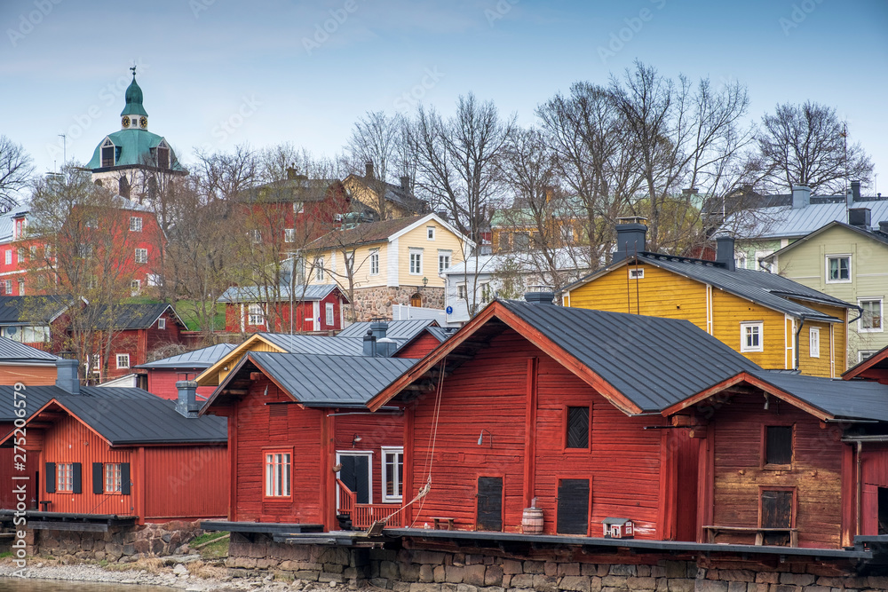  Red wooden houses barns on the river bank in the city of Porvoo Finland 