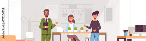 couple coworkers pointing at new female employee introducing hired worker to the team concept modern co-working center office interior flat portrait horizontal