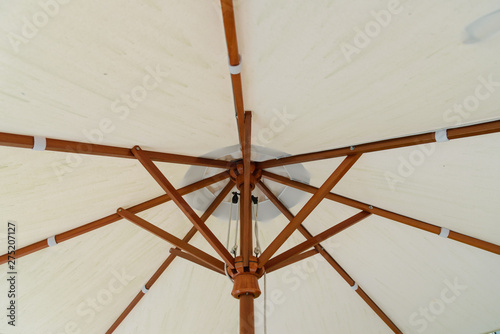 detail of under white handmade umbrella, protect sunlight in sunny day.