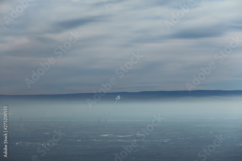 Windräder unter einer Nebeldecke und Wolkendecke