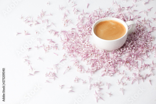 Morning Cup of coffee and a lilac flowers on light background, top view. Cozy Breakfast. Flat lay style. Female woman day, mother day, saint Valentine