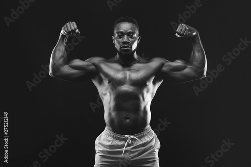 African bodybuilder demonstrating his strong muscular body