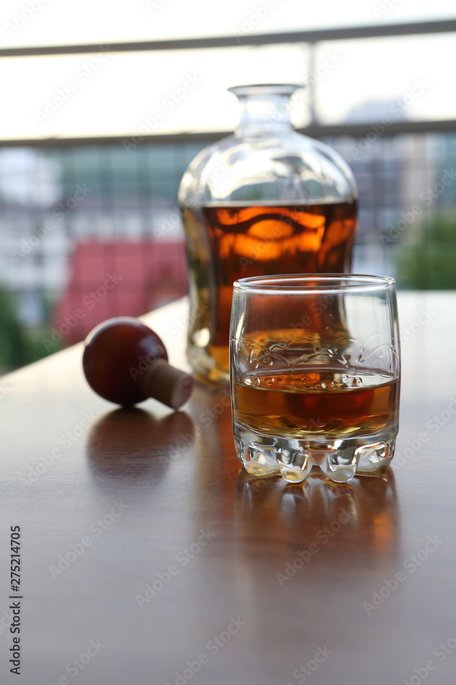 glass of whiskey and ice on wooden table glass of whiskey and ice on wooden table