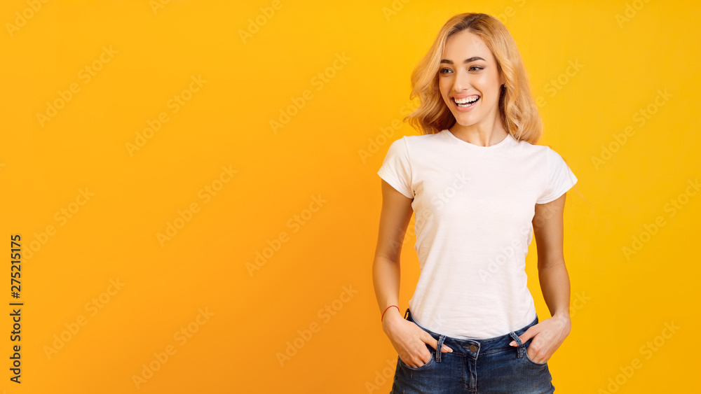 Young Woman In White T-Shirt On Yellow Background Young Woman In White T-Shirt On Yellow Background