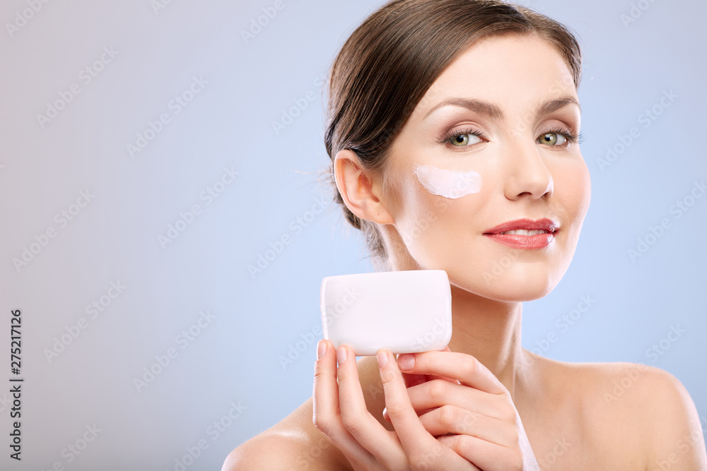 Beauty portrait of woman with clean skin holding cream jar. Beauty portrait of woman with clean skin holding cream jar.