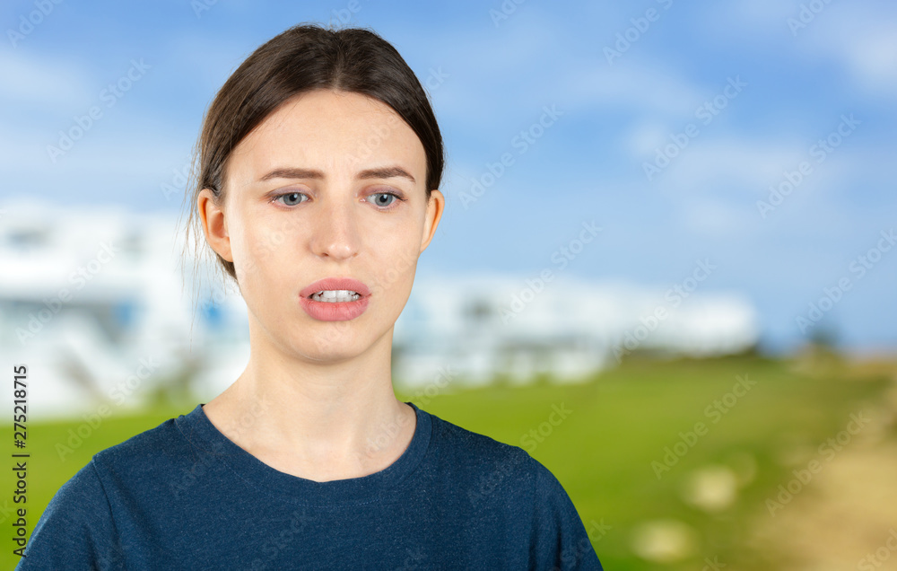 Headshot portrait of worried young woman about to start crying