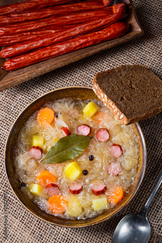 rustic sauerkraut soup with bacon and sausage photo