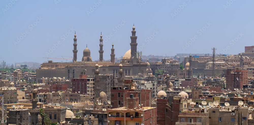 Aerial cityscape view of old Cairo, Egypt with Old grunge buildings and Sultan Hasan Mosque in far distance