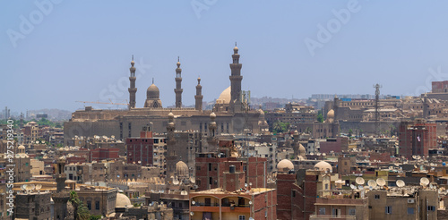Aerial cityscape view of old Cairo, Egypt with Old grunge buildings and Sultan Hasan Mosque in far distance