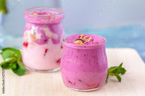 healthy products for breakfast, granola and fresh berries on white table