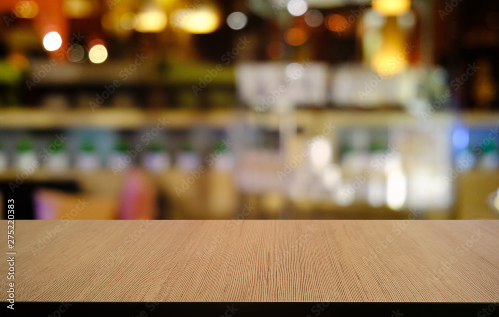 Empty dark wooden table in front of abstract blurred bokeh background of restaurant . can be used for display or montage your products.Mock up for space.