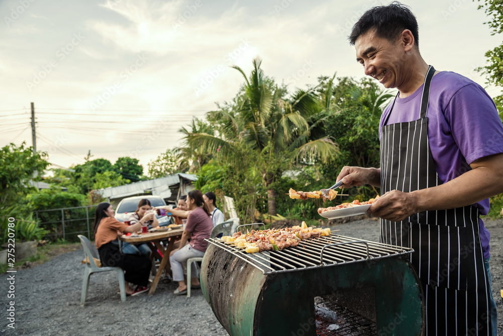 BBQ party group of people at barbecue dinner friends having food