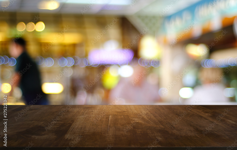 Empty dark wooden table in front of abstract blurred bokeh background of restaurant . can be used for display or montage your products.Mock up for space. Empty dark wooden table in front of abstract blurred bokeh background of restaurant . can be used for display or montage your products.Mock up for space.